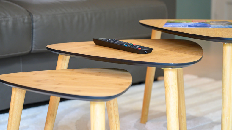 Set of three nesting tables in front of a living room sofa