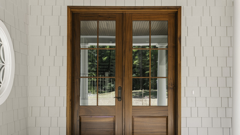 Classic wooden glass front door with see-through glass panels.