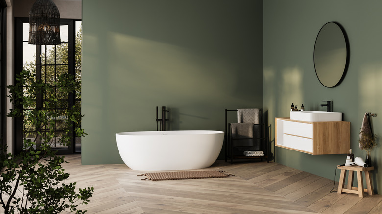 Modern bathroom with green and wood tones.