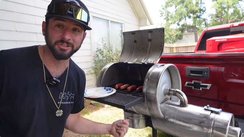 Making hot dogs on beer keg grill