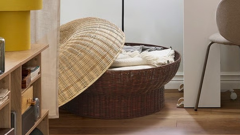 IKEA's PS 2026 ottoman with storage, holding a collection of shoes