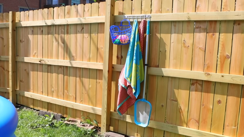 Dollar Tree wall-mounted rack used for outdoor storage