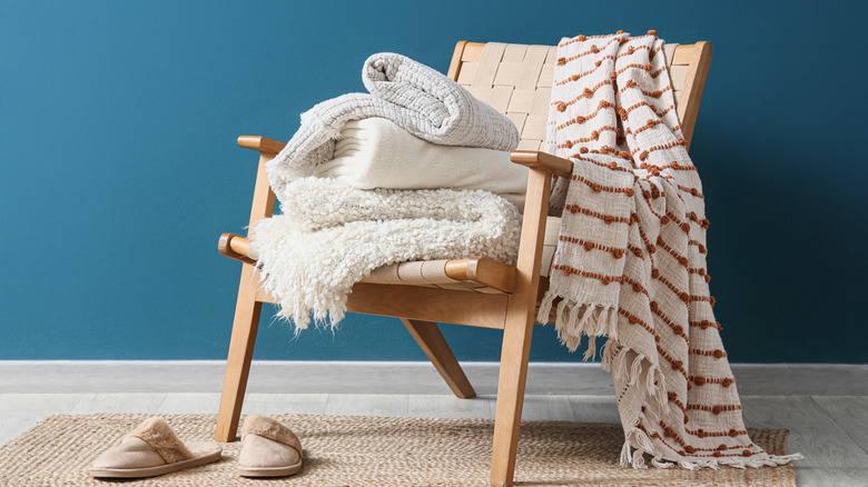 Accent chair with blankets on seat and back