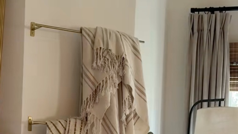 Blanket hung on towel bar mounted on wall