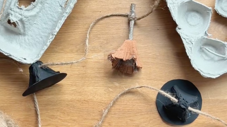 Halloween witches hat and broomstick made using egg cartons