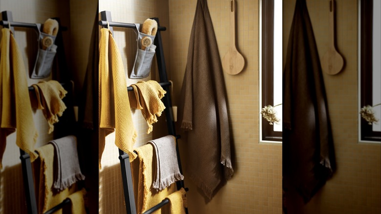 A black IKEA VILTRO towel ladder in a yellow, retro bathroom