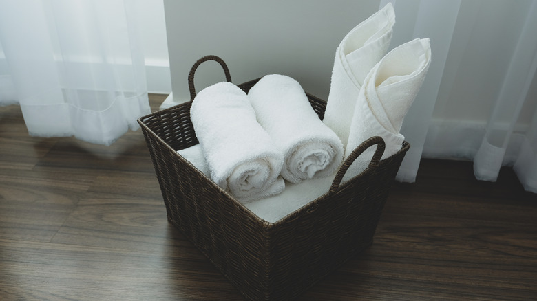 bathroom towels stores on floor in basket