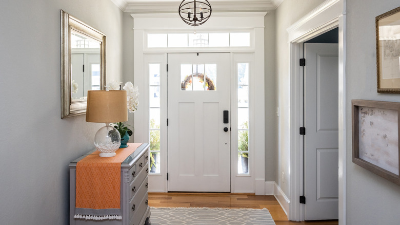 Small front entryway interior with storage console and rug