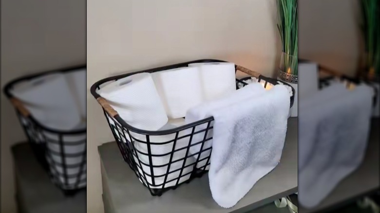 Upgraded Dollar Tree basket with wrapped handles holding toilet paper