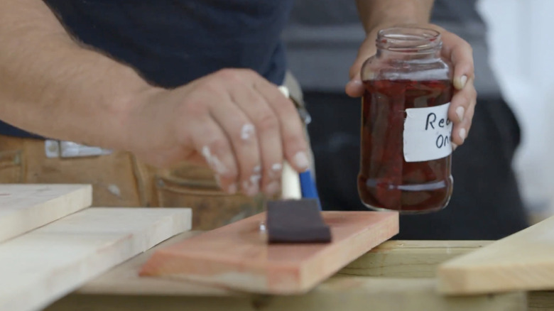 Woodworker applying stain made from red onion skins