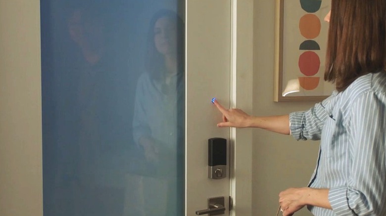 Person operating Feather River Switch Smart Glass Door installed in home