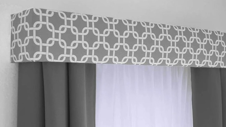 Cornice board with drapes for windows or doors.