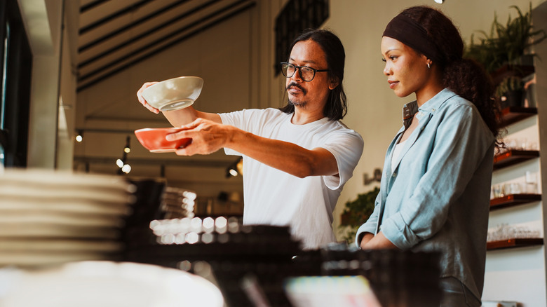 A couple analyzing bowls in a store