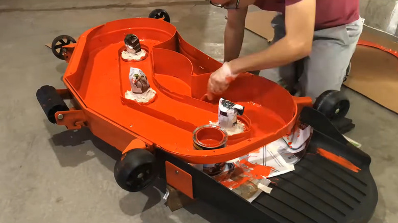 Underside of freshly painted lawn mower