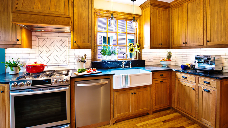 A kitchen with oak cabinets and stainless steel appliances