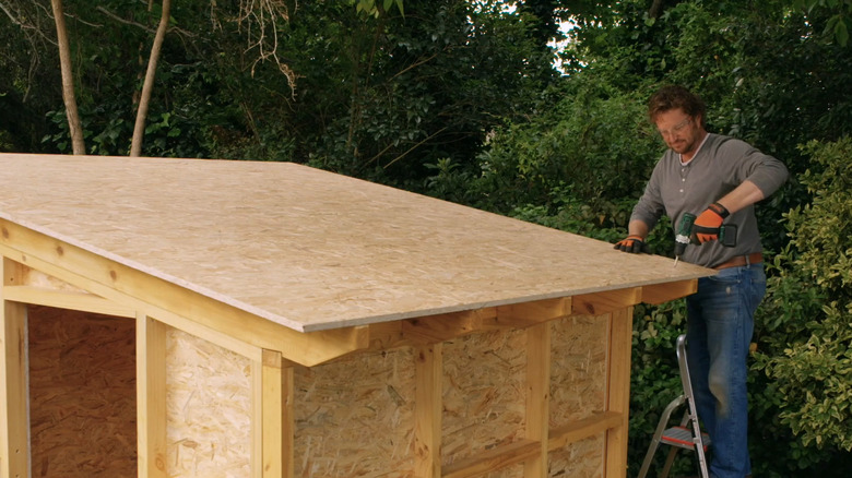 Man building a shed with OSB