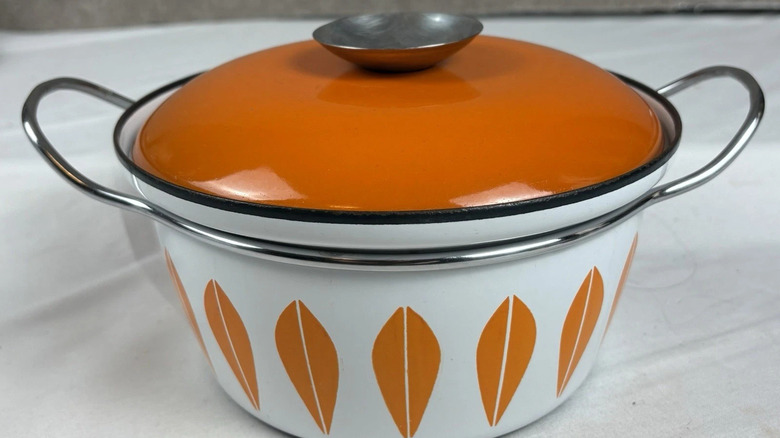 A white and orange lotus Cathrineholm dish with an orange lid