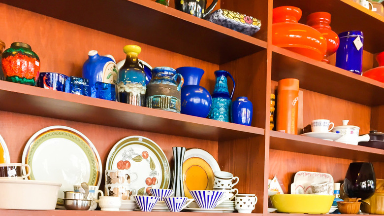 A wooden shelf holding vintage kitchenware