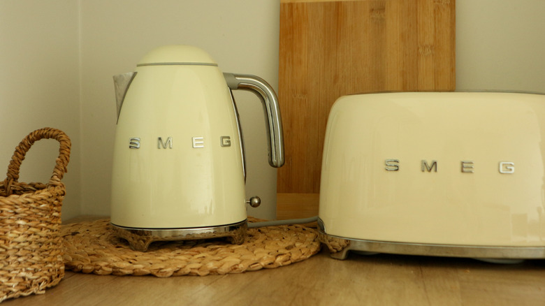 butter-yellow Smeg electric kettle and toaster on a kitchen counter