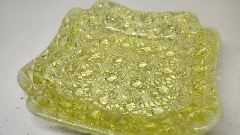 A yellow Vaseline glass square dish