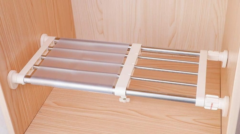 Hershii Closet Tension Shelf set up in wood cabinet