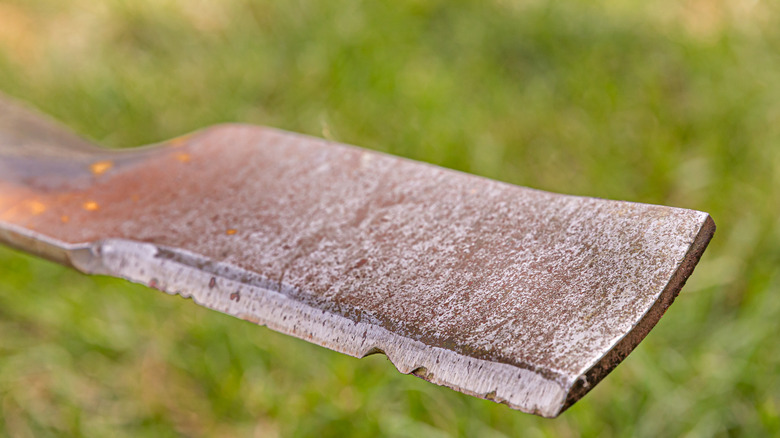 Close up of a dull lawnmower blade.