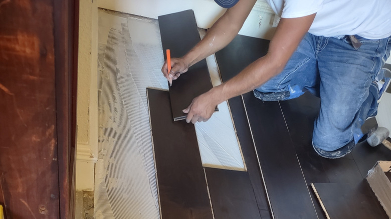 Person installing engineered hardwood flooring