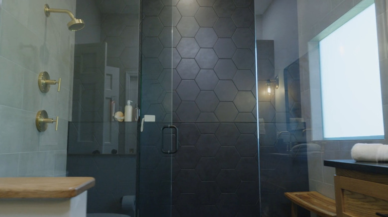 Black hexagonal tiles in bathroom shower
