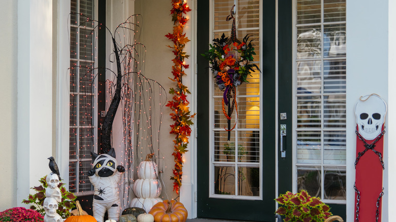 A front door with fall and Halloween decor