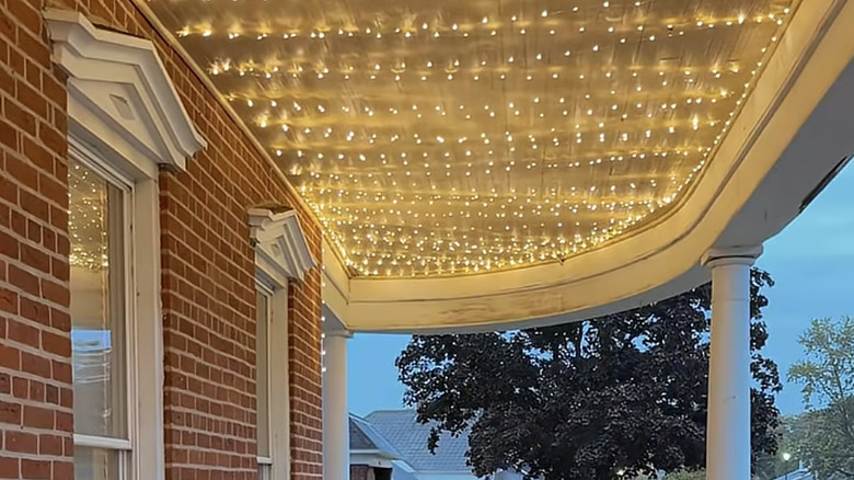 fairly lights strung across the a covered porch ceiling