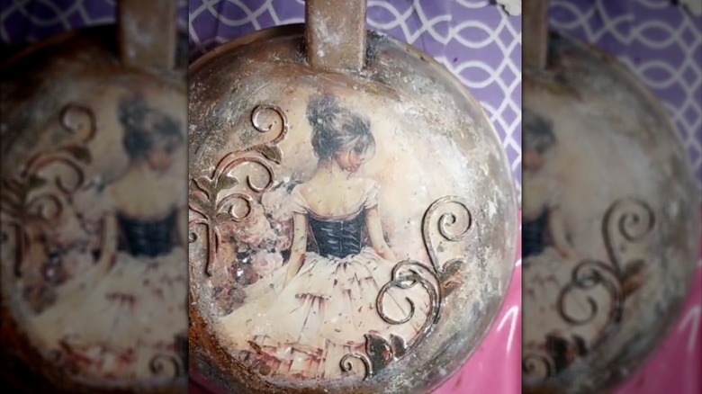 Vintage girl art on the back of an antique metal frying pan
