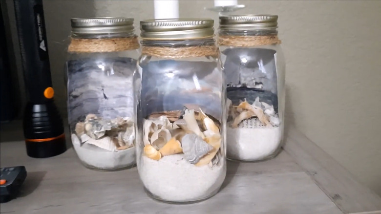 Jars filled with sand and shells from the beach