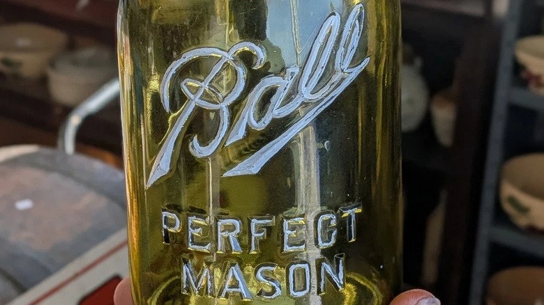 Close-up of a rare olive green Ball mason jar sold on ebay