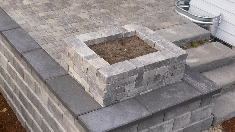 A raised bed or planter made from patio pavers