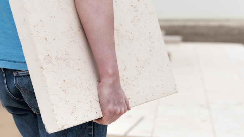 A person holding a paver