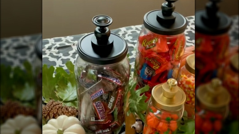 Pickle jars turned into apothecary-style storage with knobs on the lids