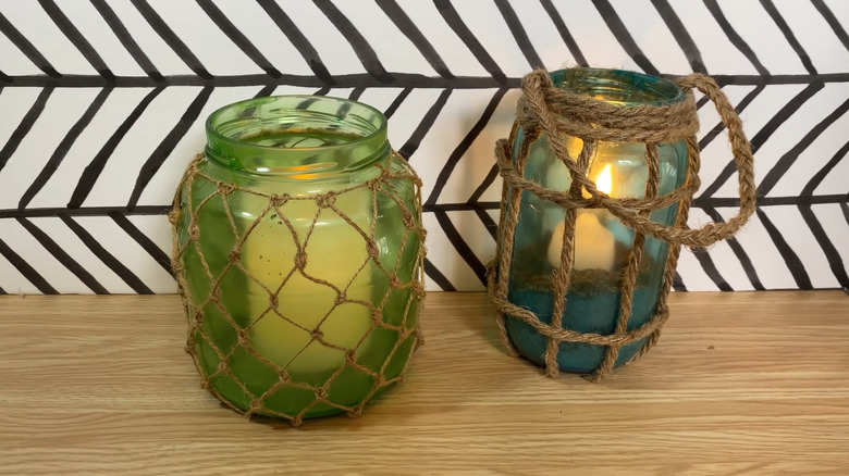 Nautical-themed candle holders made from pickle jars, tinted, and wrapped in twine