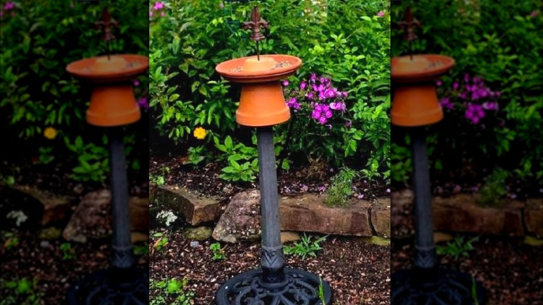 DIY birdfeeder made from a metal stand, old planter pot, and saucer