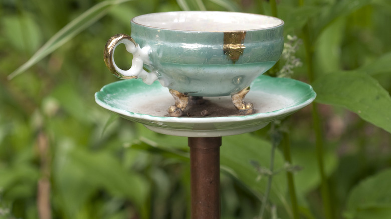Teacup and saucer on a stand in garden
