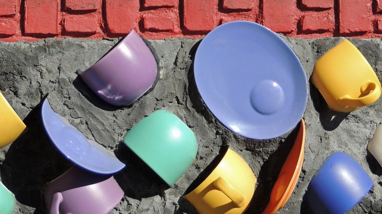 Colorful mugs and plates in cement art piece