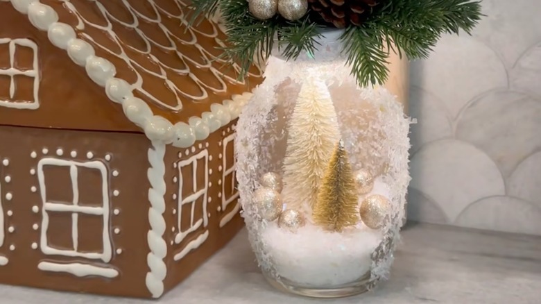 Christmas tree scene in a large glass vase