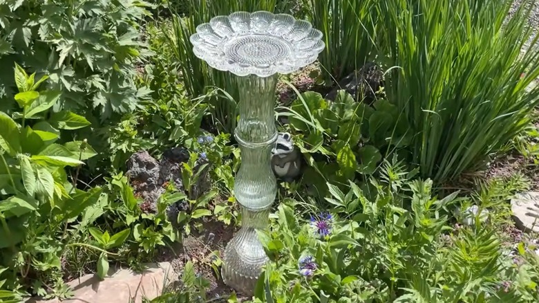DIY birdbath in yard made from glass vases and bowl