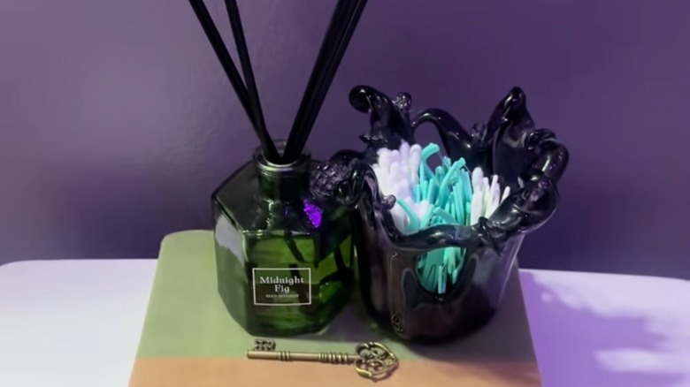 Decorative vase used to store q-tips and floss picks