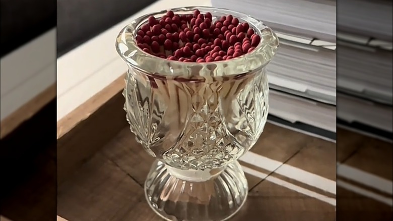 Small crystal vase used as holder for matches