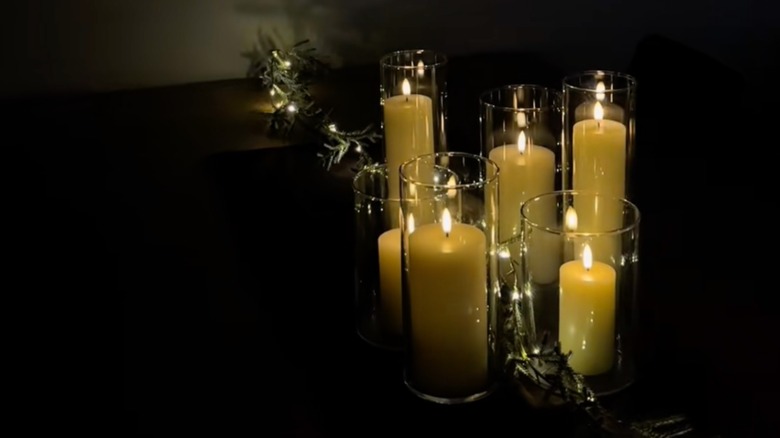Tall glass vases used to hold lit pillar candles