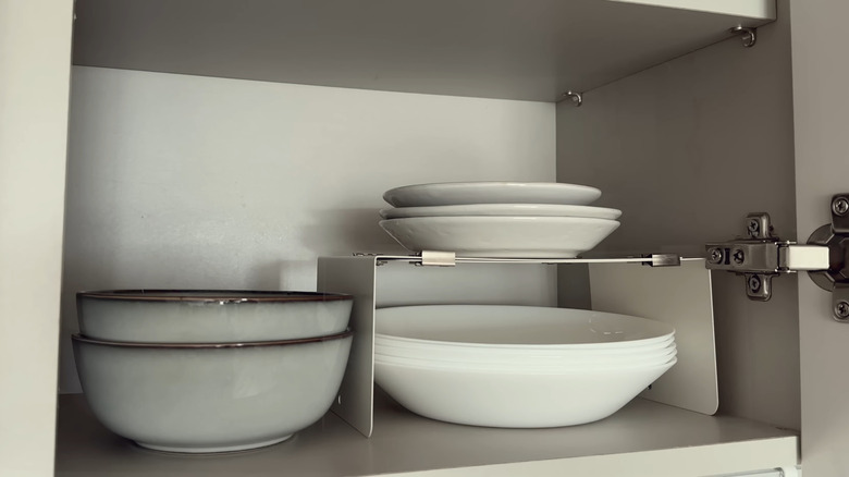 White dishware stacked in a cupboard
