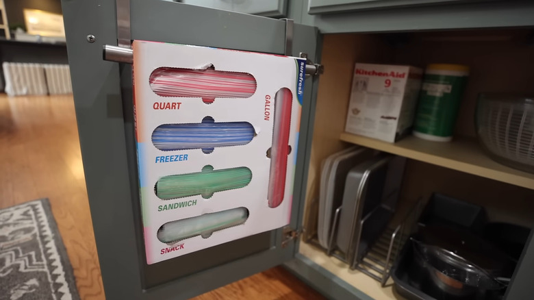 Hanging plastic storage bags on back of cabinet door