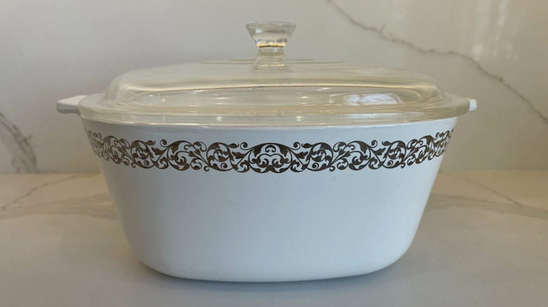 Platinum filigree CorningWare dish on a marble surface