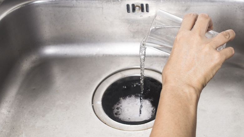 baking soda being poured in drain