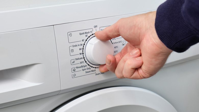 someone selects a warm-washing machine cycle